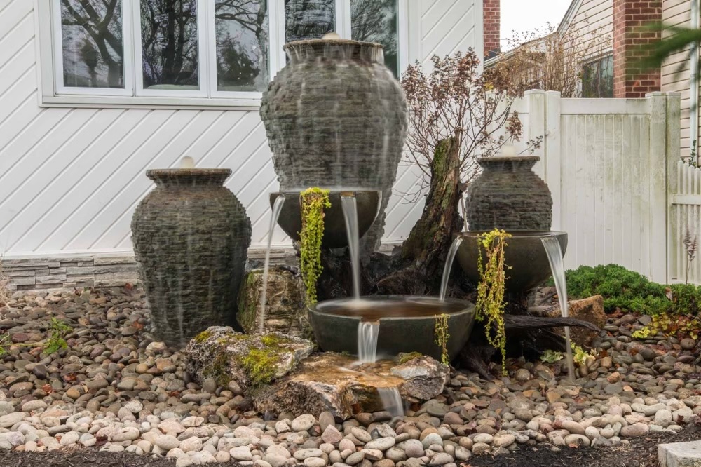 Stone fountain in landscaped garden setting