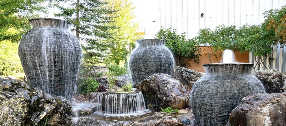Backyard fountain with planted surround